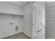 Utility area for laundry with tile floors, white paint, and open shelving at 1422 Hudson Pl, Longmont, CO 80501