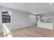 Spacious living room flowing into a modern kitchen, hardwood floors, and bright windows create a light and airy feel at 1422 Hudson Pl, Longmont, CO 80501
