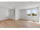 Large living room with wood flooring, neutral color palette, and ample natural light showcasing an elegant and modern design at 1422 Hudson Pl, Longmont, CO 80501