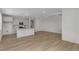 Open concept living space with modern kitchen, light hardwood floors, and neutral paint for a move-in ready home at 1422 Hudson Pl, Longmont, CO 80501