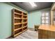 Finished basement room with custom wood shelving, painted walls and gray flooring at 11153 W 17Th Ave # 101, Lakewood, CO 80215