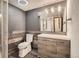 Modern bathroom with wood accent wall, stylish vanity, and glass-enclosed shower at 11153 W 17Th Ave # 101, Lakewood, CO 80215