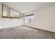 Spacious bedroom with carpeted floors, large window, and ample natural light at 11153 W 17Th Ave # 101, Lakewood, CO 80215