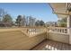 Inviting deck overlooking a serene landscape with trees and rooftops under a clear sky at 11153 W 17Th Ave # 101, Lakewood, CO 80215