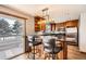 Eat-in kitchen features sleek black countertops, stainless appliances, and convenient bar seating at 11153 W 17Th Ave # 101, Lakewood, CO 80215
