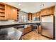 Modern kitchen includes stainless steel appliances, granite countertops, and custom wood cabinetry at 11153 W 17Th Ave # 101, Lakewood, CO 80215