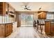 Kitchen features wood cabinets, stone countertops, bar seating, and a bright adjacent dining area at 11153 W 17Th Ave # 101, Lakewood, CO 80215