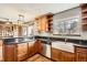 Rustic kitchen features wood cabinets, stainless steel appliances, and a large farmhouse sink at 11153 W 17Th Ave # 101, Lakewood, CO 80215