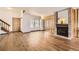 Spacious living room highlighting wood floors, a brick fireplace, and abundant natural light at 11153 W 17Th Ave # 101, Lakewood, CO 80215