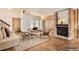 Bright living room boasts wood floors, a brick fireplace, and comfortable seating arrangements at 11153 W 17Th Ave # 101, Lakewood, CO 80215