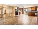 Open-concept living area featuring hardwood floors, a cozy fireplace, and seamless kitchen access at 11153 W 17Th Ave # 101, Lakewood, CO 80215