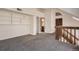 Spacious loft area with built-in shelving and a staircase leading to another level at 11153 W 17Th Ave # 101, Lakewood, CO 80215