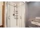 Updated shower with modern fixtures, glass enclosure, and built-in shelving at 11153 W 17Th Ave # 101, Lakewood, CO 80215