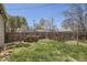 Spacious backyard with lush green grass and a wooden table set for outdoor dining at 1065 6Th St, Berthoud, CO 80513