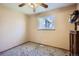 Cozy bedroom with carpet flooring, ceiling fan, and a bright window providing natural light at 1065 6Th St, Berthoud, CO 80513