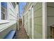 A narrow area between houses with a gravel path and shed doors at 1065 6Th St, Berthoud, CO 80513