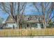 Charming home with a wood picket fence, mature trees, and well-maintained landscaping at 1065 6Th St, Berthoud, CO 80513