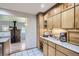 Kitchen with granite countertops, wood cabinets, and views into the adjacent living room at 1065 6Th St, Berthoud, CO 80513