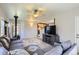 Open living area with a gray sectional sofa, wood-burning stove, and view into the kitchen at 1065 6Th St, Berthoud, CO 80513