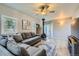 Comfortable living room with a gray sectional sofa, wood-burning stove, and light wood flooring at 1065 6Th St, Berthoud, CO 80513
