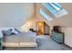 Large main bedroom featuring two skylights, neutral decor, and comfortable seating area at 1065 6Th St, Berthoud, CO 80513