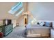 Bright and spacious main bedroom with skylights, a comfortable bed, and unique furniture at 1065 6Th St, Berthoud, CO 80513