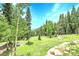 Large, well-maintained backyard with mature trees and ample space, perfect for outdoor activities and relaxation at 1176 Raven Ridge Rd, Idaho Springs, CO 80452