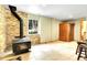 Basement featuring stone accent wall, wood burning stove, sauna, and tile flooring at 1176 Raven Ridge Rd, Idaho Springs, CO 80452