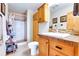 Well-lit bathroom features tiled shower, vanity with stone countertop, and wood cabinetry at 1176 Raven Ridge Rd, Idaho Springs, CO 80452