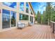 Outdoor deck with seating area showcasing views of surrounding trees and blue sky at 1176 Raven Ridge Rd, Idaho Springs, CO 80452