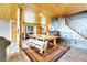 Spacious dining area features wooden table, bench, and unique architectural elements, creating inviting space at 1176 Raven Ridge Rd, Idaho Springs, CO 80452