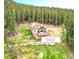 Charming mountain home with a deck, surrounded by lush forest and mature trees at 1176 Raven Ridge Rd, Idaho Springs, CO 80452