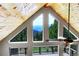 View from inside showcasing large windows, wood ceiling, and stunning mountain and forest views at 1176 Raven Ridge Rd, Idaho Springs, CO 80452