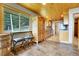 Rustic kitchen boasts natural wood cabinets, stainless appliances, bar seating, and beautiful views at 1176 Raven Ridge Rd, Idaho Springs, CO 80452