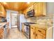 Functional kitchen with wood cabinets, tile backsplash, and stainless steel range and oven at 1176 Raven Ridge Rd, Idaho Springs, CO 80452