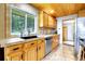 Well-lit kitchen featuring wood cabinets, stainless steel appliances, and a scenic window view at 1176 Raven Ridge Rd, Idaho Springs, CO 80452