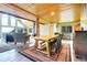 Open-concept living room showcases vaulted ceilings, stone fireplace, and picturesque outdoor views at 1176 Raven Ridge Rd, Idaho Springs, CO 80452