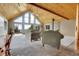 Comfortable living room with vaulted wood ceiling, view windows, and comfortable seating at 1176 Raven Ridge Rd, Idaho Springs, CO 80452