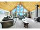 A spacious living room featuring vaulted ceilings, a wood burning stove, and mountain views at 1176 Raven Ridge Rd, Idaho Springs, CO 80452