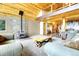 Spacious living room with stone fireplace, wood ceiling, and rustic-style coffee table at 1176 Raven Ridge Rd, Idaho Springs, CO 80452