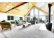 A spacious living room featuring vaulted ceilings, a wood burning stove, and mountain views at 1176 Raven Ridge Rd, Idaho Springs, CO 80452