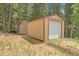 View of two outdoor storage sheds nestled among trees, providing ample space for tools and equipment at 1176 Raven Ridge Rd, Idaho Springs, CO 80452