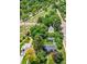 Aerial view showcases the home nestled among mature trees with a neighborhood path visible at 1901 S Adams St, Denver, CO 80210