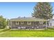 Charming home featuring a covered patio with outdoor seating and a well-manicured lawn, perfect for relaxation at 1901 S Adams St, Denver, CO 80210
