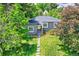 Charming single-story home with lush, mature trees and manicured lawn at 1901 S Adams St, Denver, CO 80210
