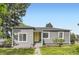 Charming single-story home featuring a well-manicured lawn and a welcoming yellow front door at 1901 S Adams St, Denver, CO 80210