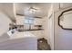 Bright kitchenette featuring stainless steel sink, white cabinetry, and in-unit laundry at 1901 S Adams St, Denver, CO 80210