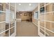 Basement room with French doors and neutral decor at 8932 Tuscany Ln, Highlands Ranch, CO 80130