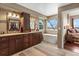 Luxurious bathroom with double vanity, soaking tub, and window at 8932 Tuscany Ln, Highlands Ranch, CO 80130