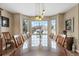 Formal dining room with hardwood floors, bay window, and a glass-top table at 8932 Tuscany Ln, Highlands Ranch, CO 80130